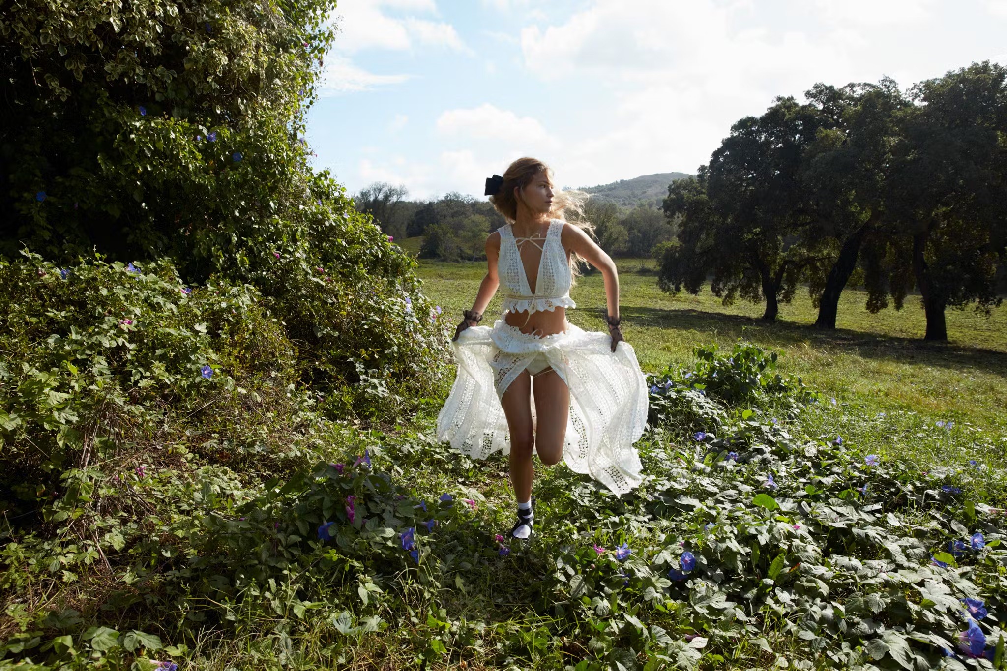 Woman with sunglasses walking down runway